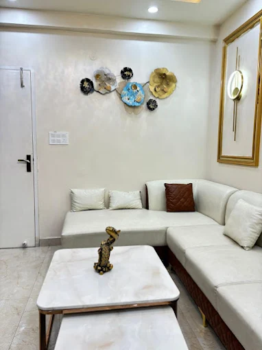 Modern lounge with varied seating, large windows, and stylish lights.